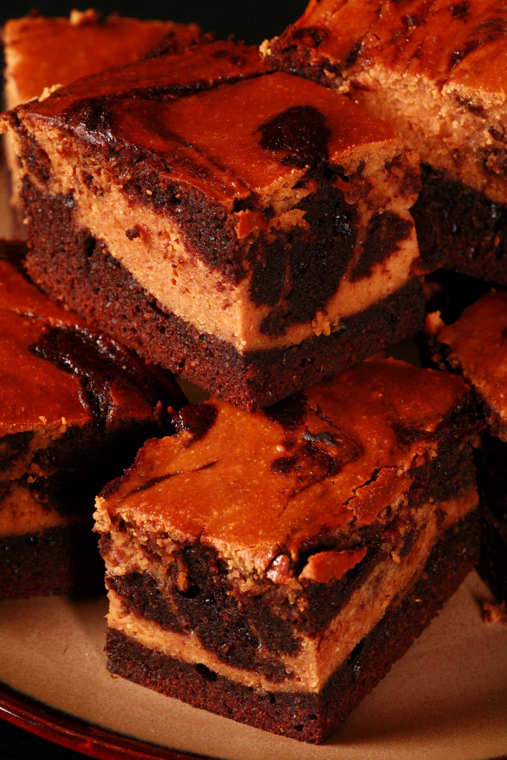 A plate of marbled keto pumpkin cheesecake brownies.