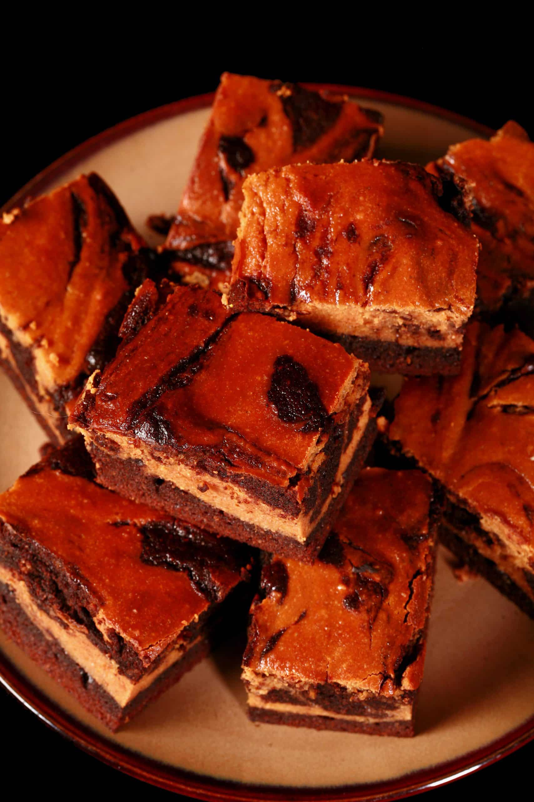 A plate of swirled low carb pumpkin cheesecake brownies.