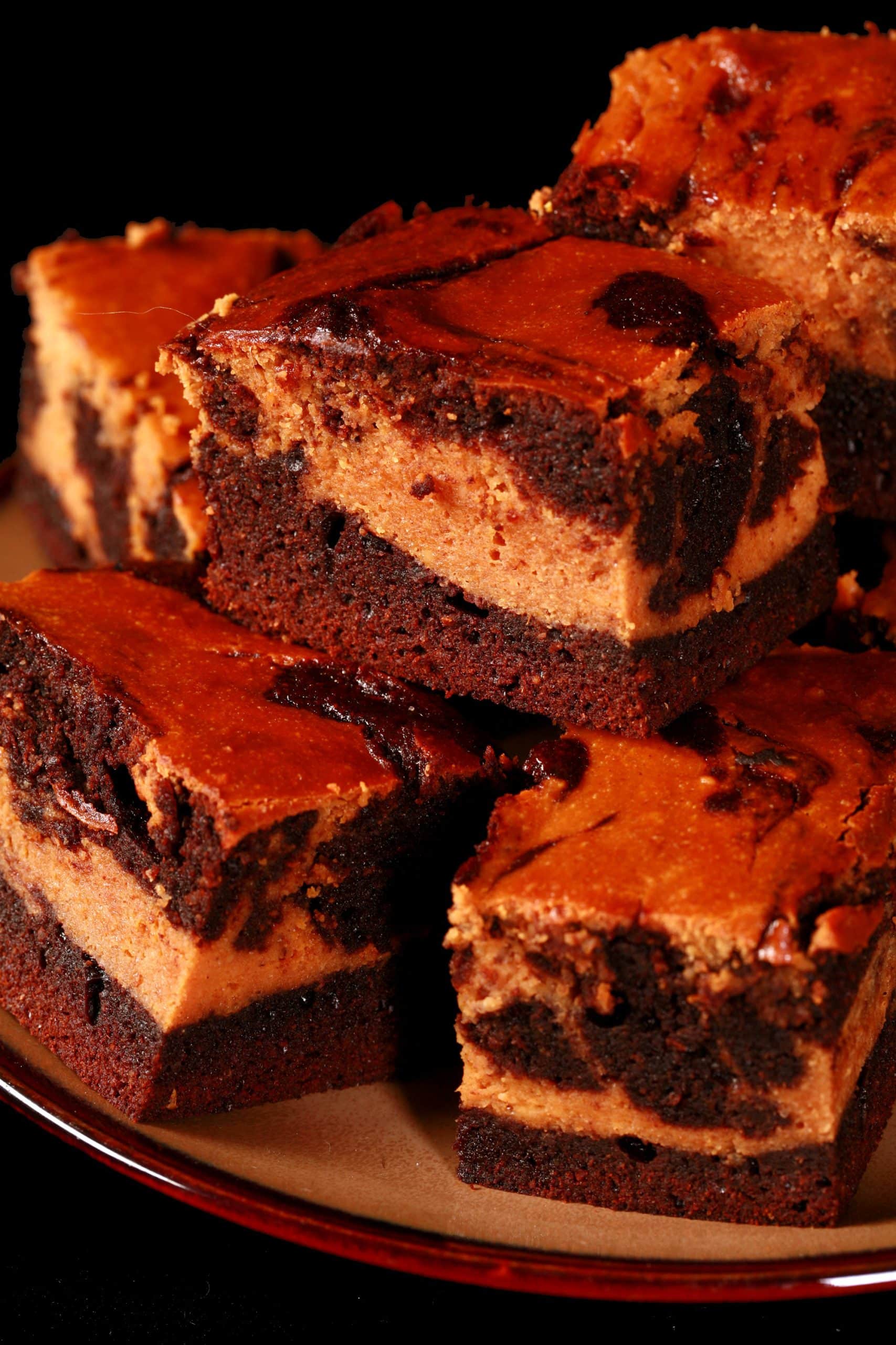 A plate of marbled keto pumpkin cheesecake brownies.