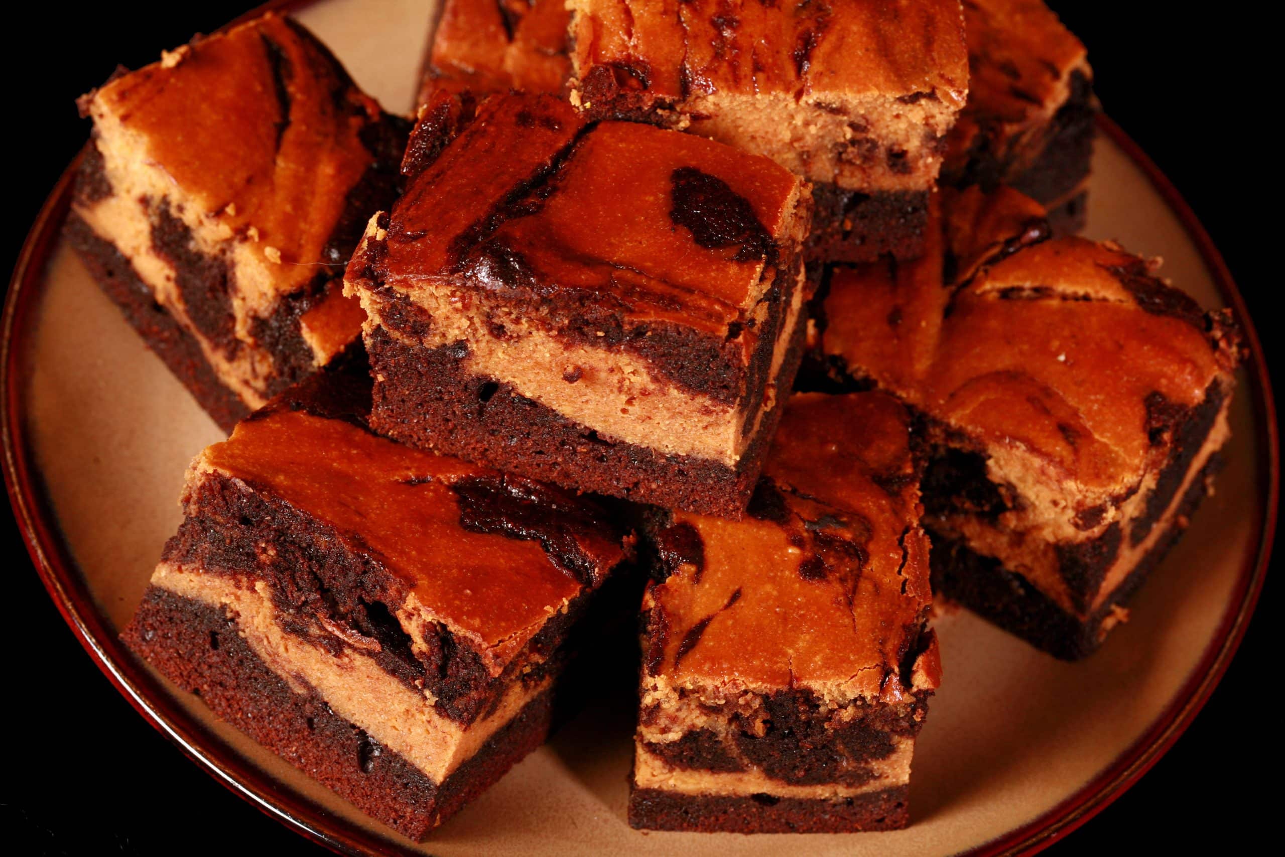 A plate of swirled low carb pumpkin cheesecake brownies.