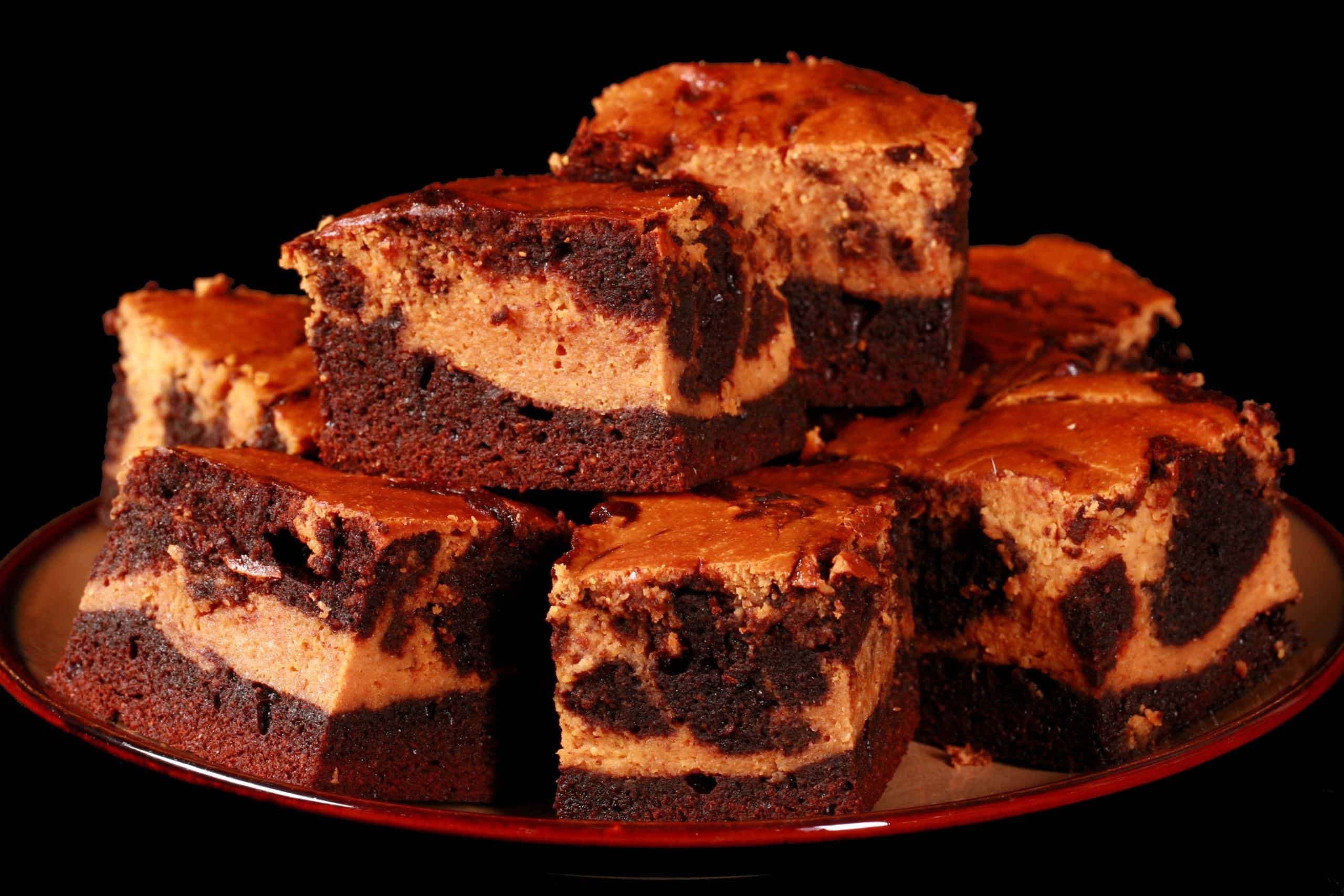 A plate of marbled keto pumpkin cheesecake brownies.