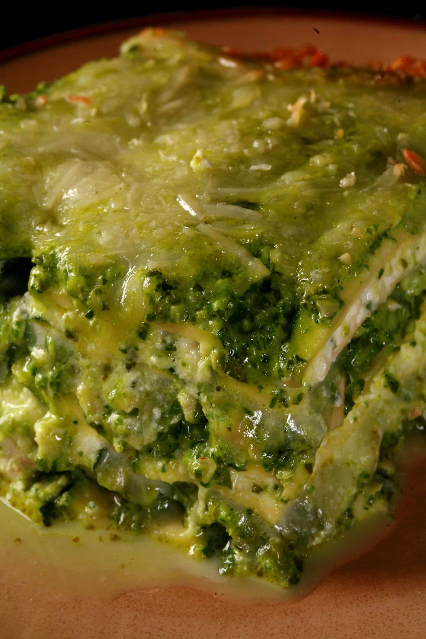 A close up photo of a serving of low carb pesto chicken lasagna.