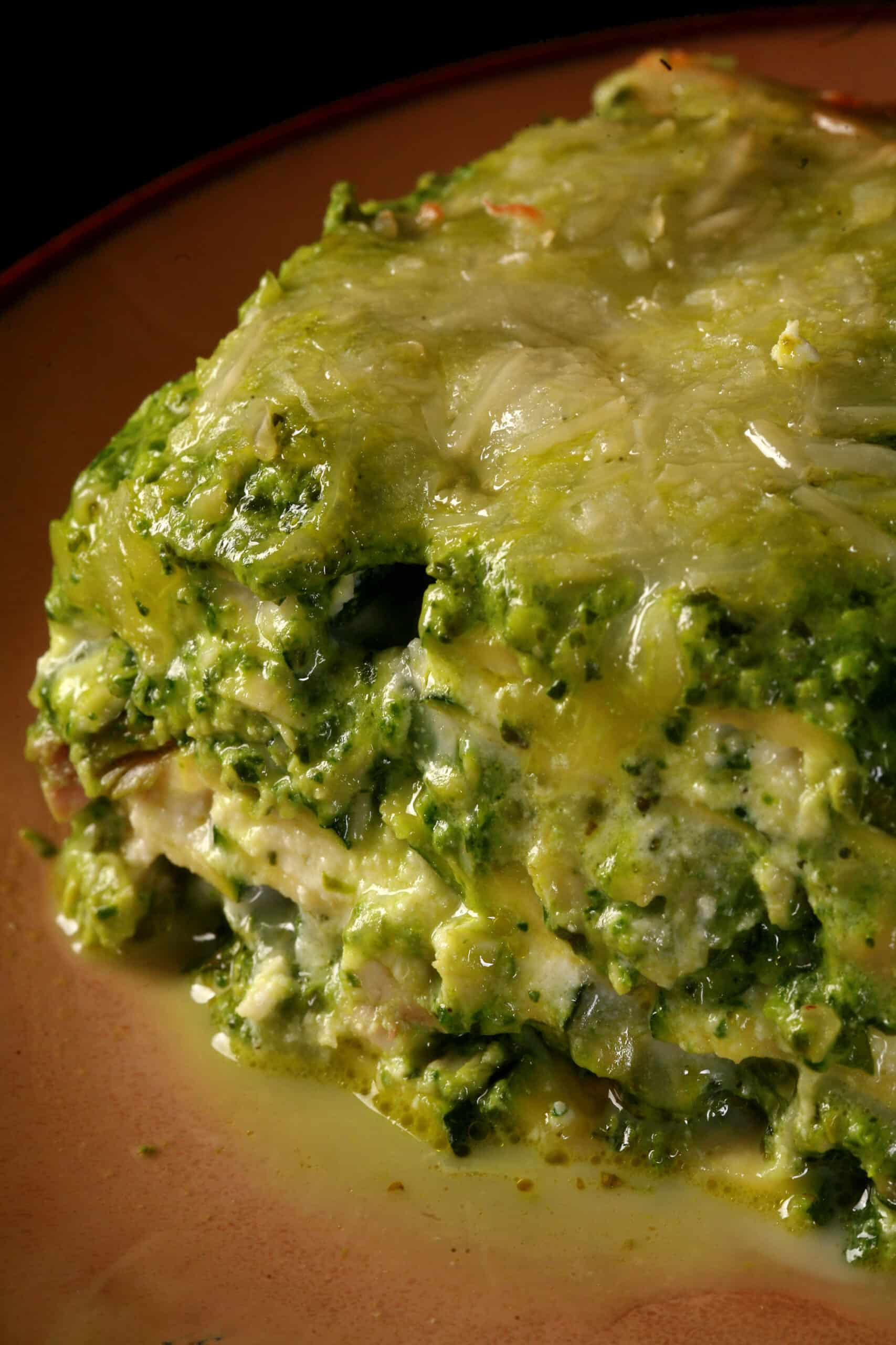 A close up photo of a serving of keto pesto chicken lasagna.