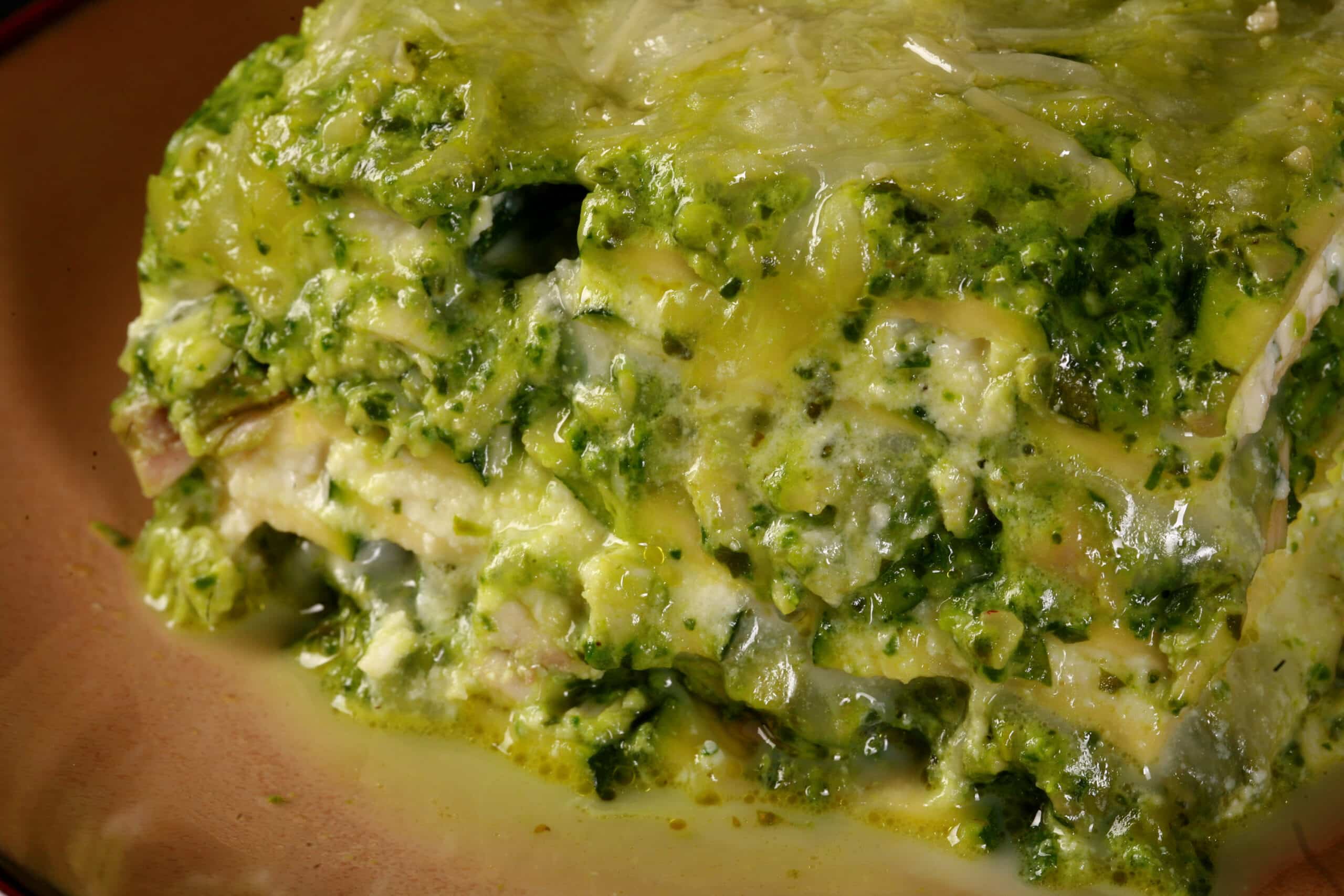 A close up photo of a serving of keto pesto chicken lasagna.