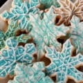 A plate of low carb sugar cookies decorated as blue and white snowflakes.