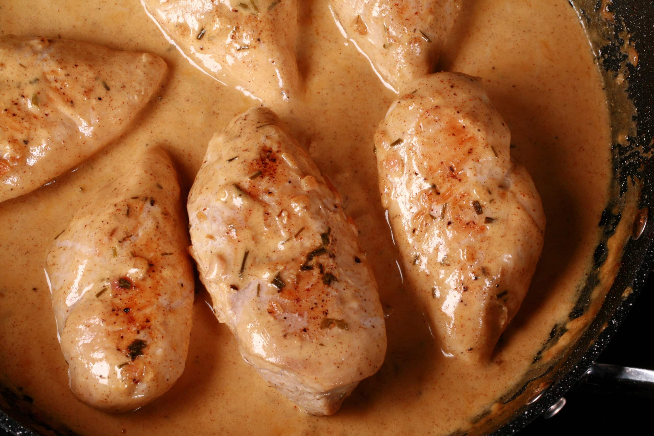 A pan of creamy mustard chicken breasts.