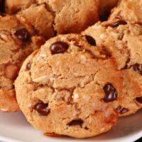 A plate of keto cowboy cookies - low carb cookies with peanut butter, coconut, chocolate chips, butterscotch chips, nuts, and more!
