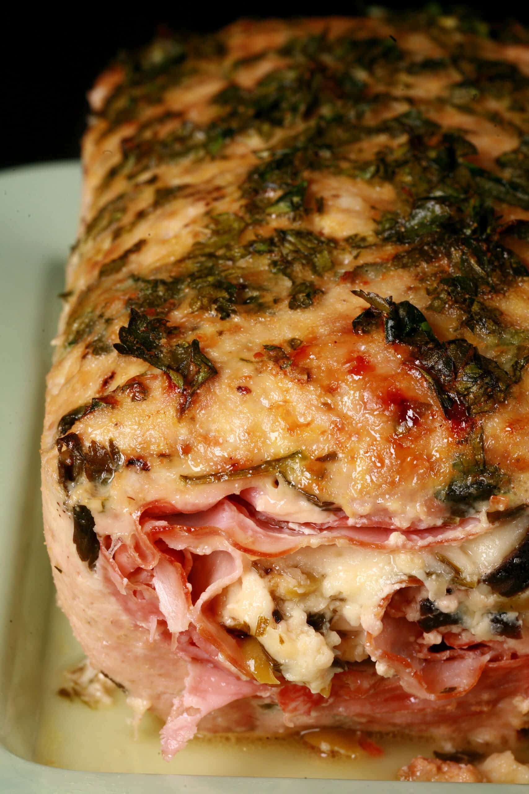 A close up view of a muffaletta stuffed meatloaf.
