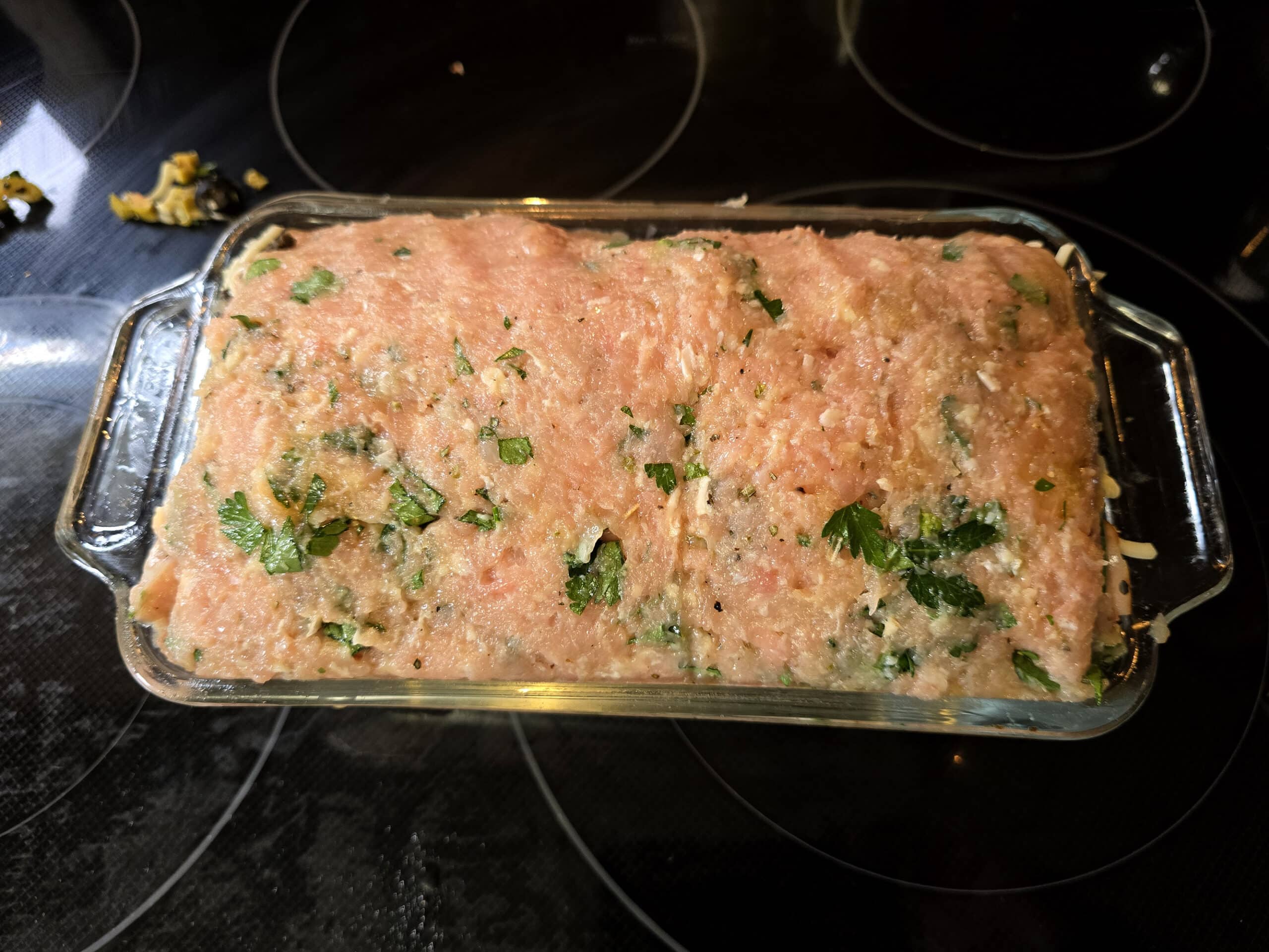The muffaletta meatloaf in a loaf pan.