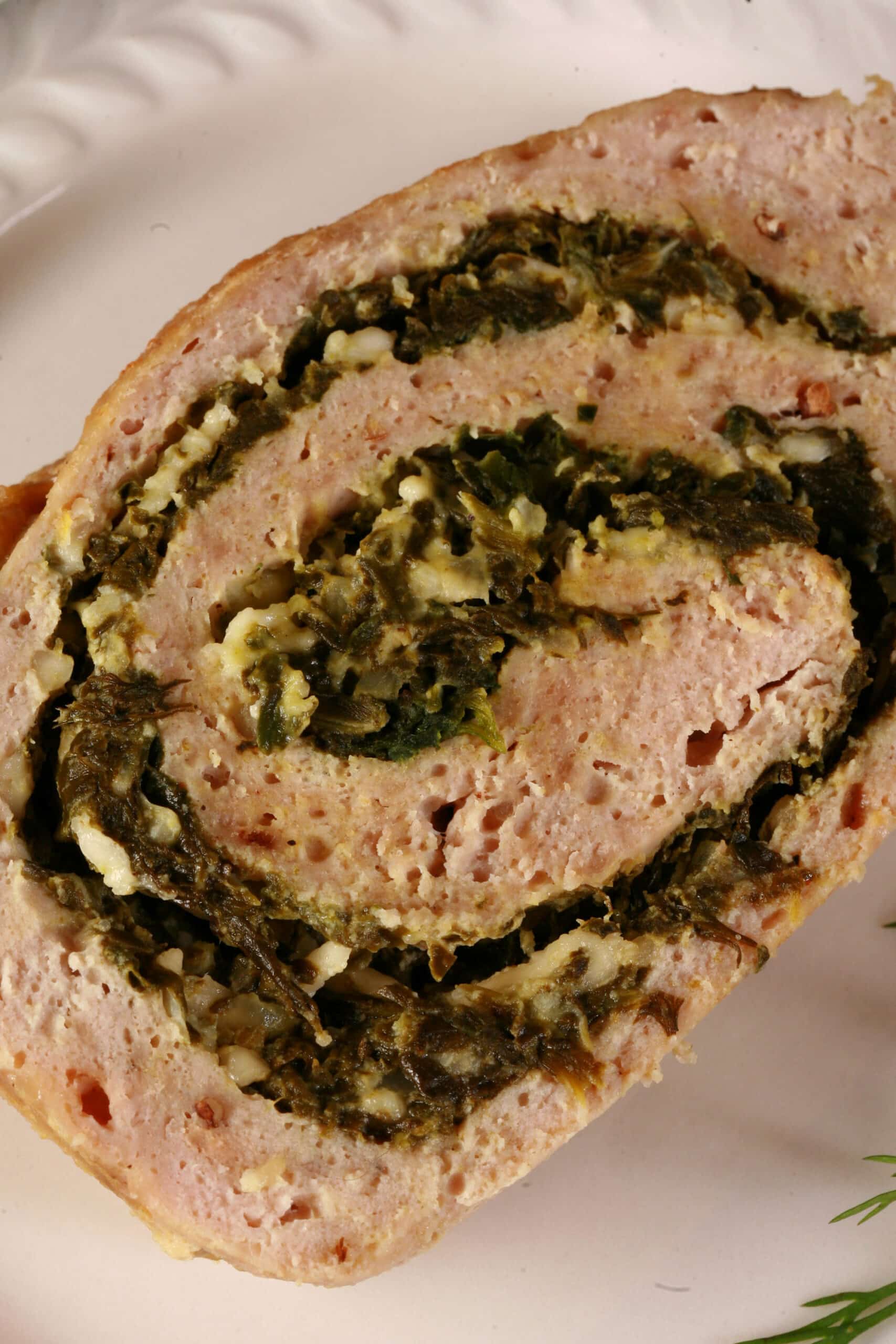 A rolled Spanakopita stuffed chicken meatloaf.