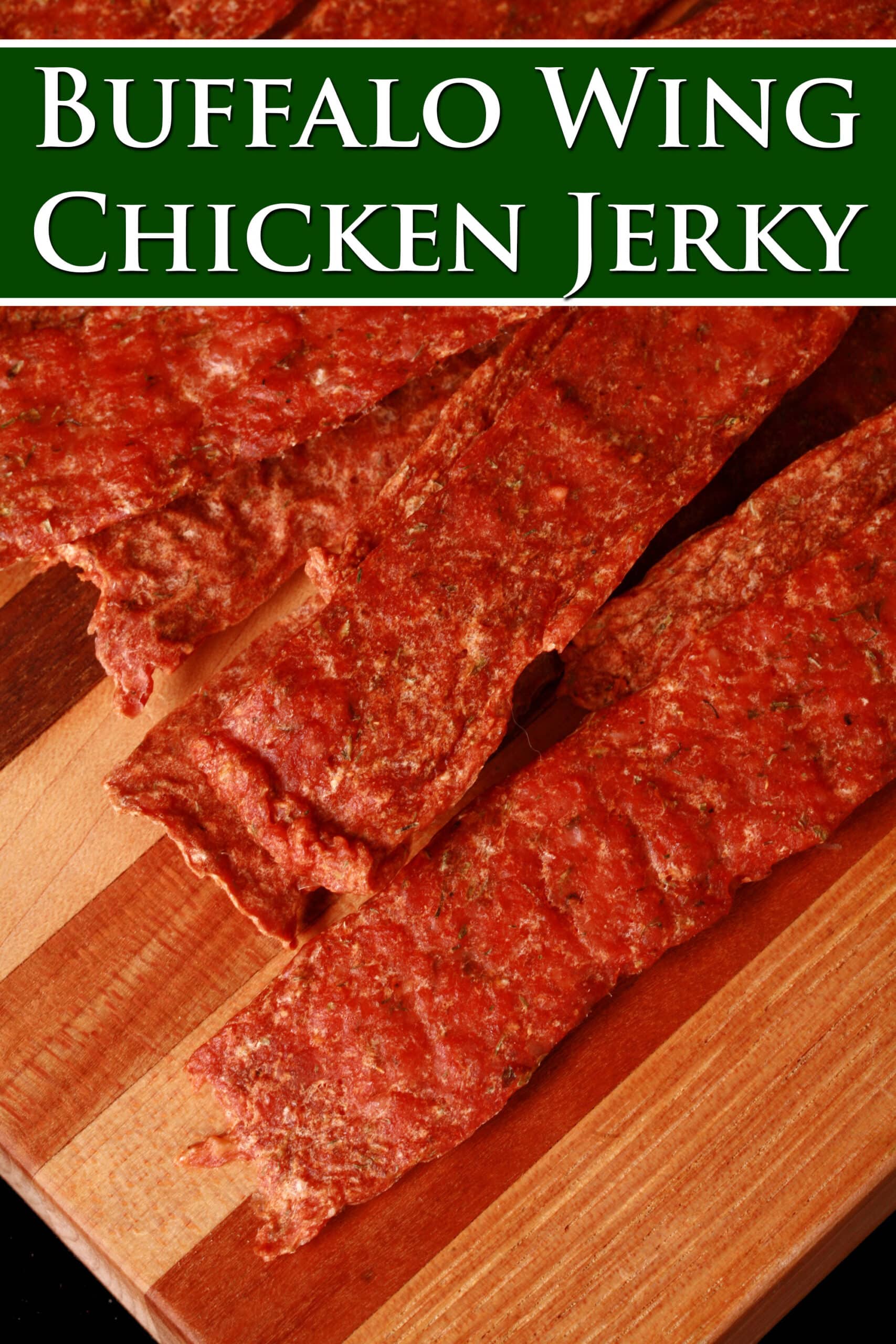 Several strips of buffalo chicken jerky on a cutting board. Overlaid text says buffalo wing chicken jerky.