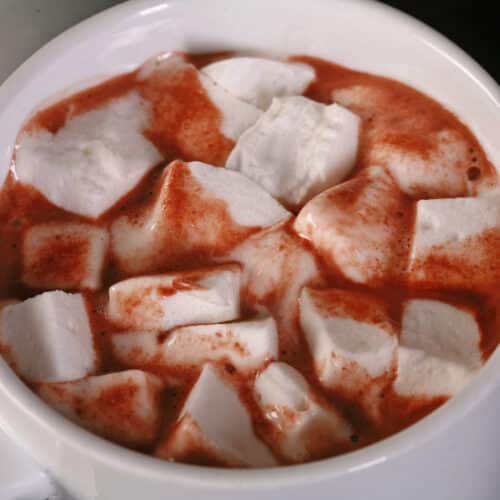 A mug of keto hot chocolate, topped with sugar free marshmallows.