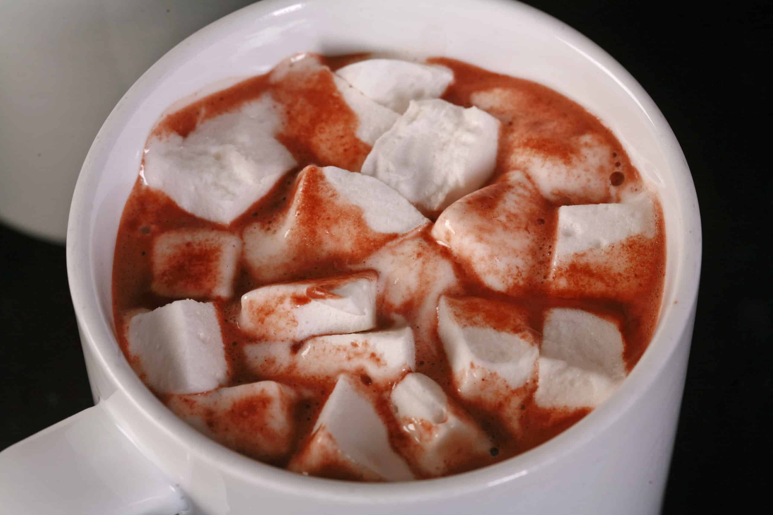 A mug of keto hot chocolate, topped with sugar free marshmallows.