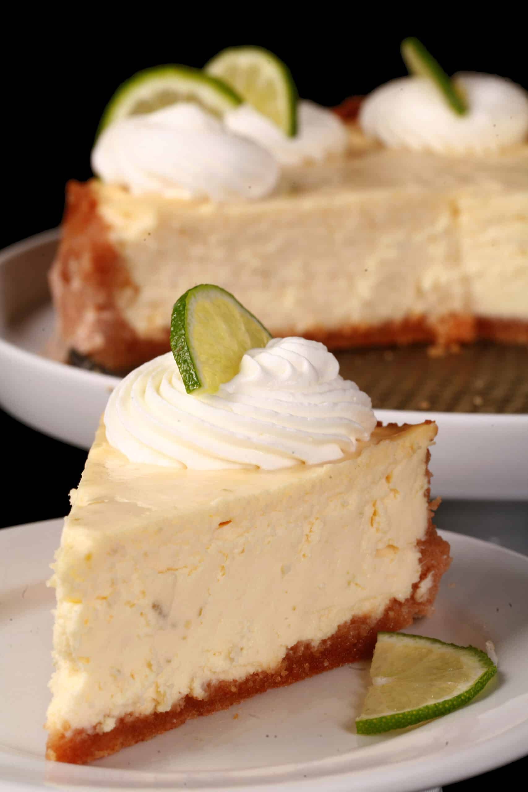 A sugar free key lime cheesecake with a slice cut out of it.