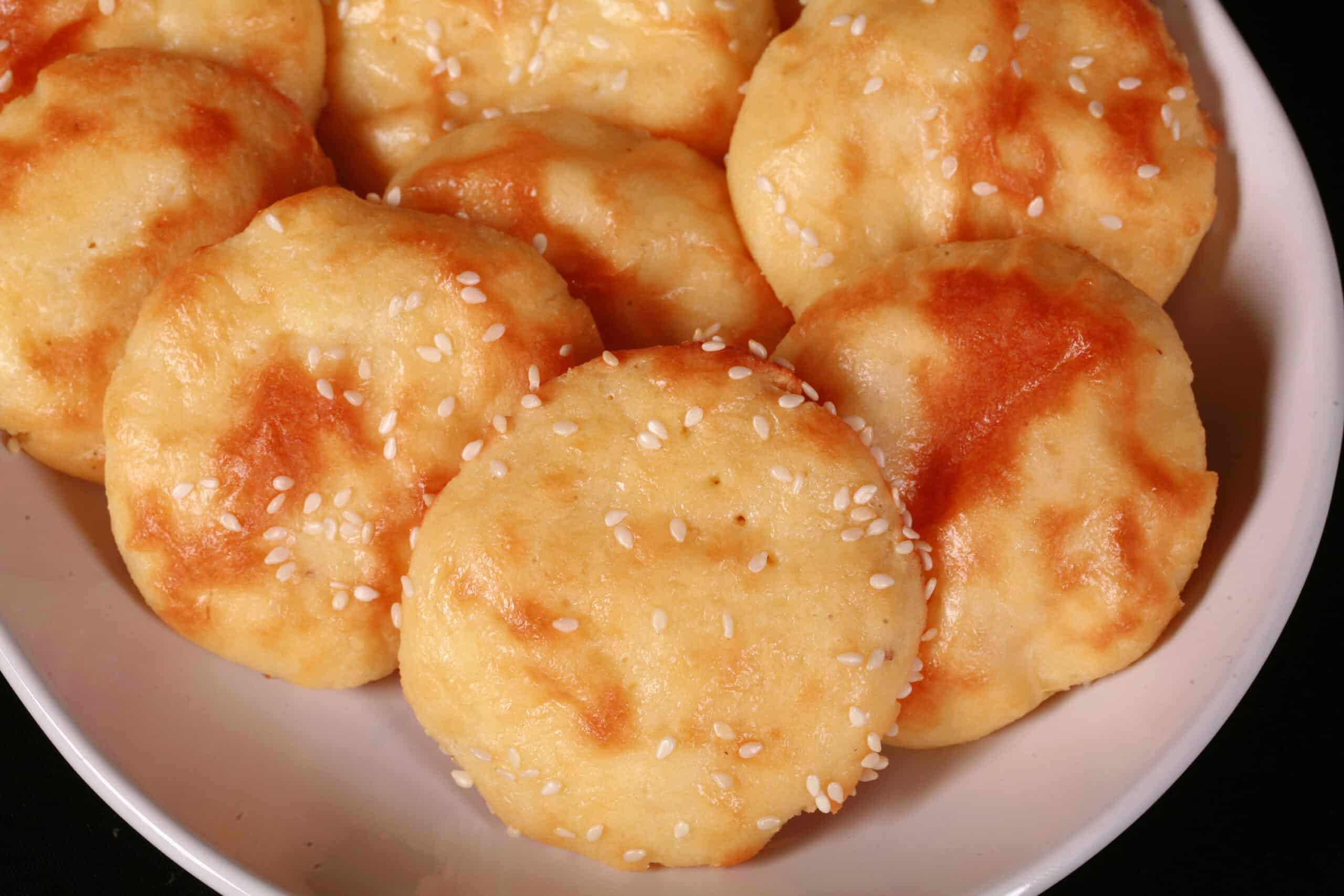 A plate of low carb mini pita rounds with sesame seeds.