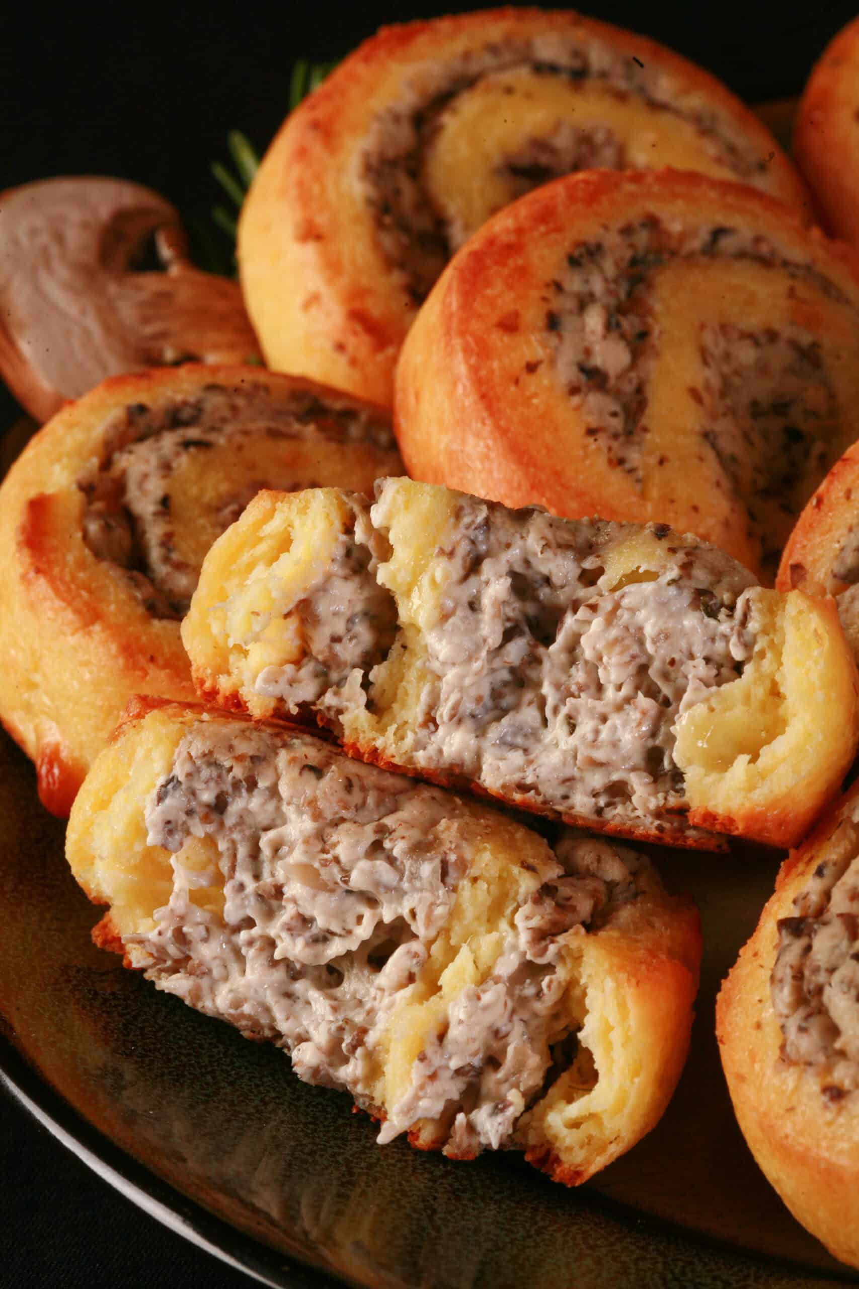 A plate of fathead pastry keto cheese and mushroom pinwheels.