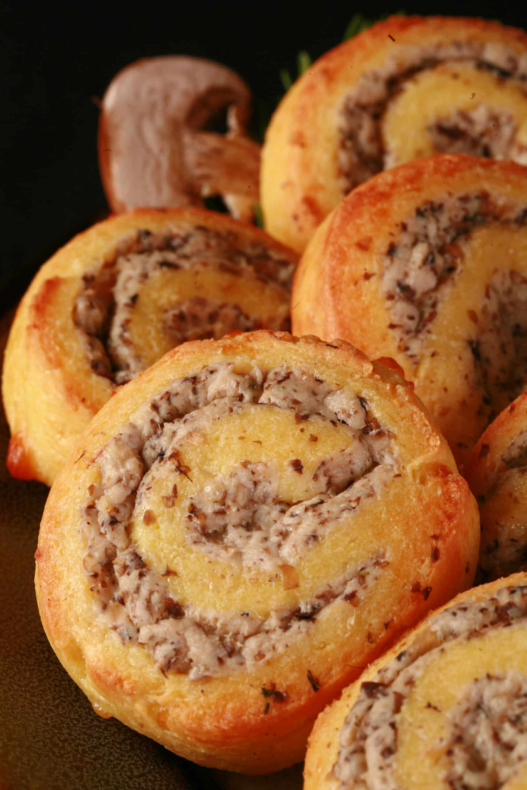 A plate of fathead pastry keto cheese and mushroom pinwheels.