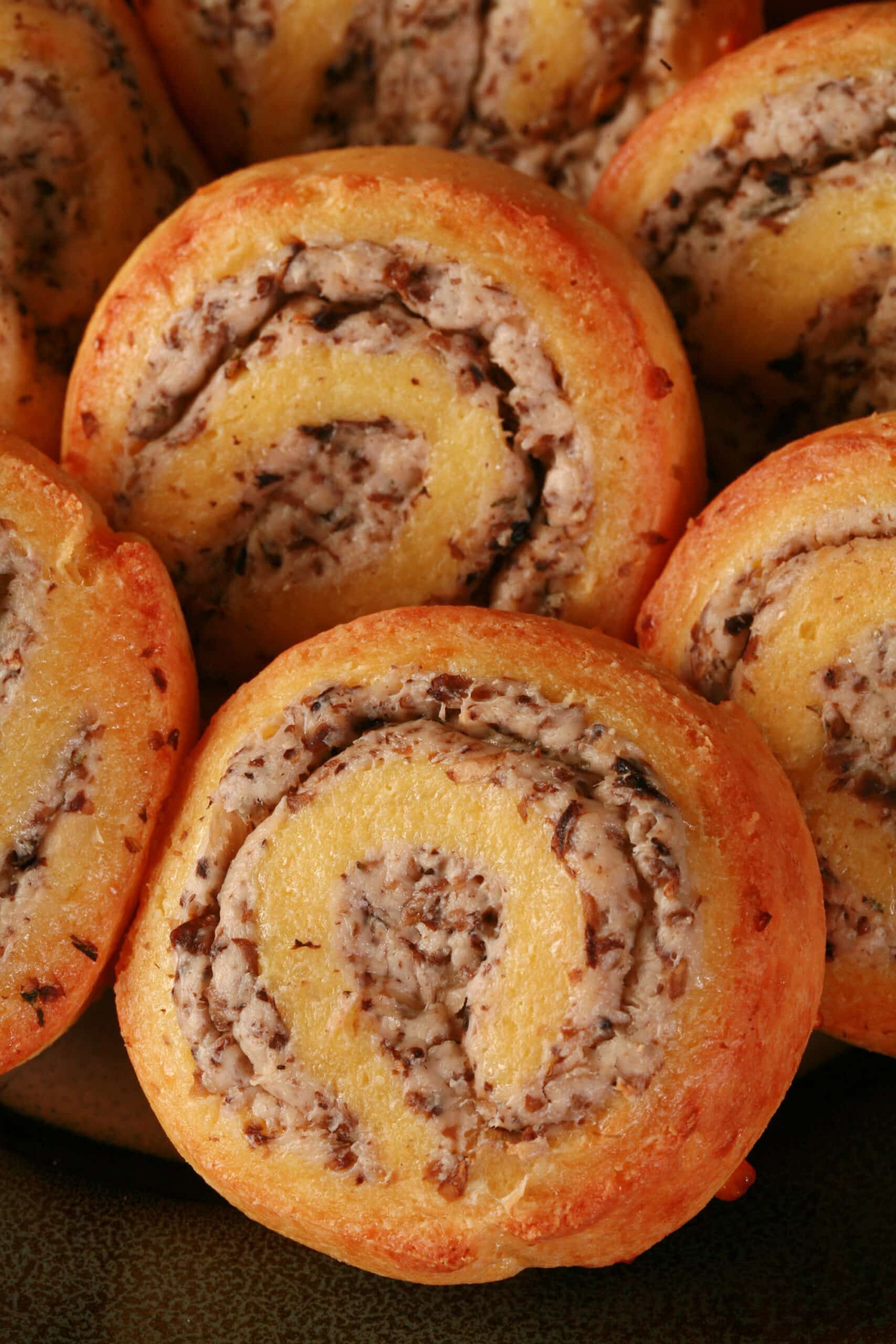 A plate of fathead pastry keto mushroom and cheese pinwheels.