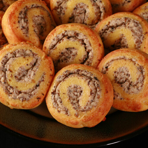A plate of fathead pastry keto cheese and mushroom pinwheels.