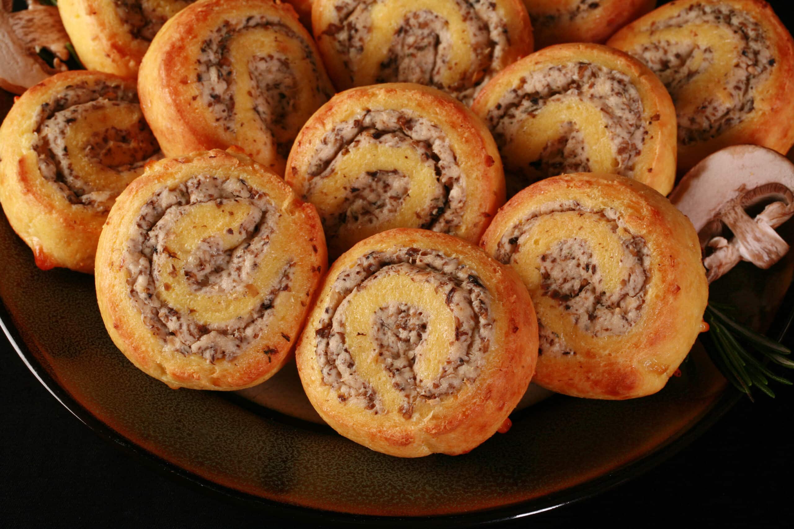 A plate of fathead pastry keto cheese and mushroom pinwheels.