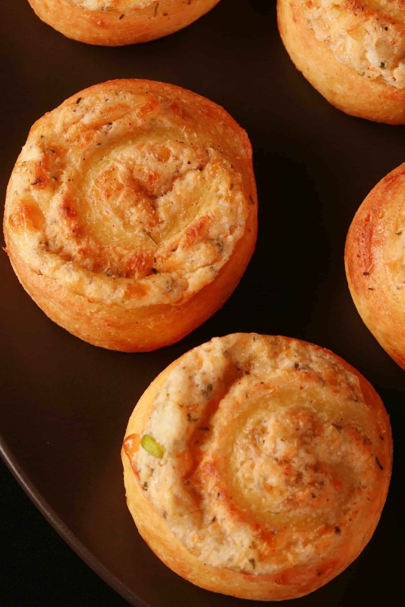 A plate of fathead pastry keto cheese and onion pinwheels.