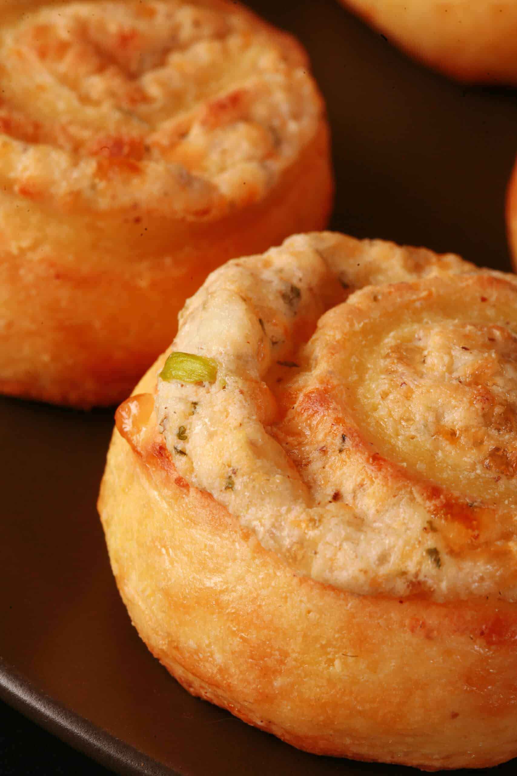 A plate of fathead pastry keto onion and cheese pinwheels.