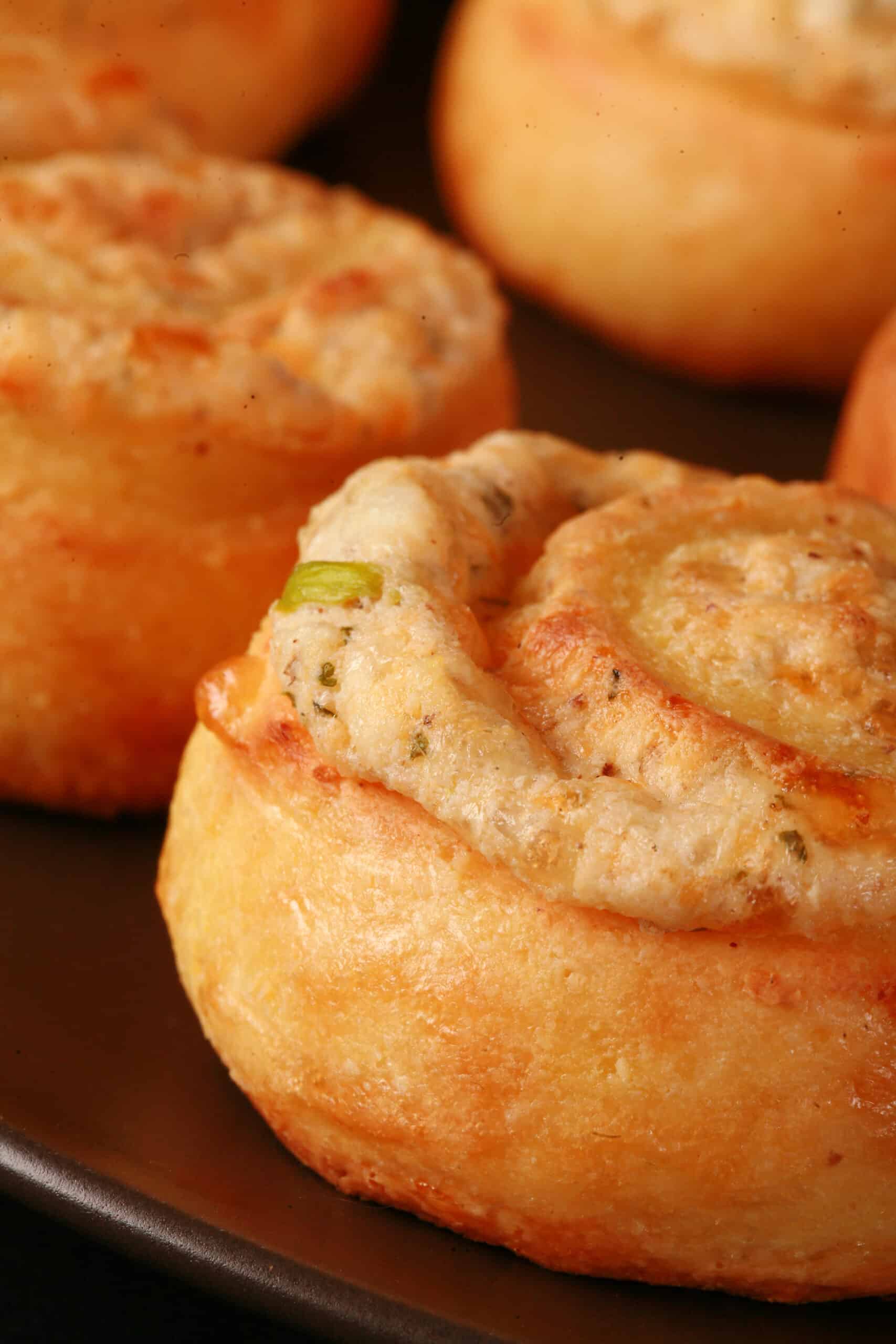 A plate of fathead pastry keto cheese and onion pinwheels.