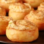 A plate of fathead pastry keto cheese and onion pinwheels.