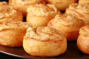 A plate of fathead pastry keto cheese and onion pinwheels.